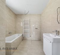 A bathroom in a family house with a bathtub, sink, and radiator on light tiles.
