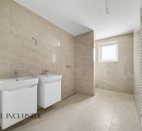 A bathroom in a family house with two sinks and ceramic tiles.