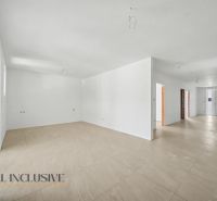 The interior of a family house with a ceramic floor and white walls ready for completion.