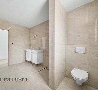 A bathroom with ceramic tiles and a double sink in a family house.