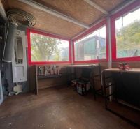 In the wooden-decorated cottage, there are tools and workbenches.