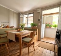 A kitchen space in a cabin with wooden decor and seating in a natural style.