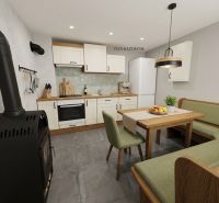A kitchen in a cabin with a fireplace, a dining table, and green upholstered seating.