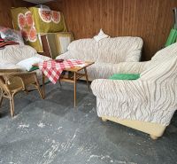 Interior of a cabin with comfortable couches, wooden paneling, and a decorative table.