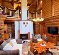 The interior of the cottage with rustic elements and cozy furniture, wooden walls and decorations.
