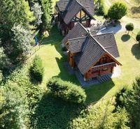 A cottage in the forest near Banská Bystrica surrounded by greenery and nature.