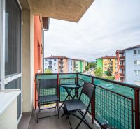 A balcony with a view of colorful buildings on Veltlínska Street in Pezinok, 2-room apartment.
