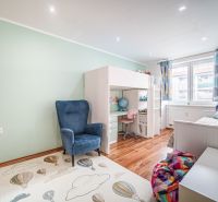 Children's room with a bunk bed, armchair, and floor with wooden decor, 2-room apartment.