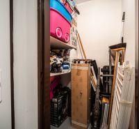 Storage space in a 2-room apartment with a shelf and various storage needs.
