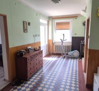 Interior of a family house with a hallway, a dresser, and an exercise machine.