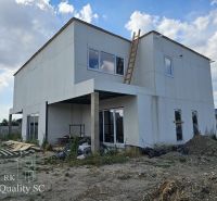 Unfinished family house on Lichnerova Street in Senec, with a white facade and a ladder.
