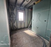 Interior construction of a family house in the renovation stage with a window and cables.