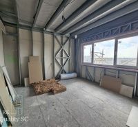 Building material in a room of a family house with a view through a large window.