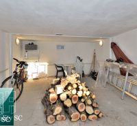 A garage in a family house with wood, a bicycle, and tools.