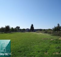 Residential plots on Vrbová Street in Jelka with a green grassy area.