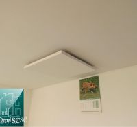 White ceiling with an infrared panel and a calendar in the Cottage.
