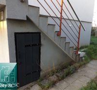 Entrance to the cottage at SUNNY LAKES SOUTH in Senec, stairs with a red railing.