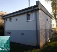 Cottage at SUNNY LAKES SOUTH in Senec, surrounded by grassland and trees.