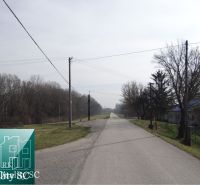 Road at the Old Port Gabčíkovo for Land - housing, surrounded by trees.