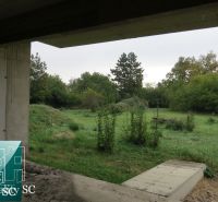 View from the construction of a family house onto a green garden in Kráľová pri Senci on Záhumenská.