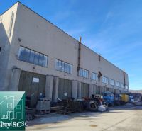 Production premises on Staviteľská Street in Bratislava III, industrial machines can be seen outside.