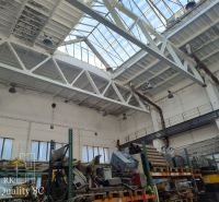 Interiors of warehouses and halls with large windows, storage shelves, and industrial lighting.