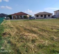 Plots - housing in Senec, grassy area with a view of family houses.