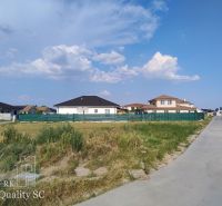 Residential plots in Senec with a view of family houses and the sky.