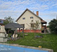 A family house on Tureň Street in the village of Tureň with a lawn and a gazebo.