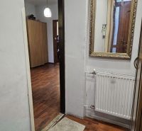 Interior of a family house with a wooden decor floor, mirror, and lighting.