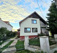 A family house in Tureň on Tureň Street surrounded by a garden and a blue sky.