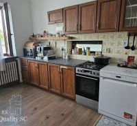A kitchen in a family house with wooden decor, cabinets, stove, dishwasher.