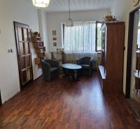 Living room in a family house with a wooden decor floor and comfortable furniture.