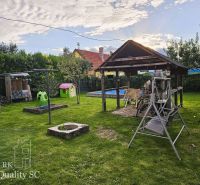 The garden of a family house on Tureň Street in Tureň with a gazebo, a swing, and a children's playground.
