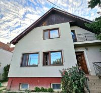 A family house in the town of Tureň on Tureň Street with a colorful facade and a garden.