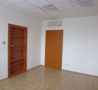 A space with white walls, a wooden decor floor, and a built-in shelf.