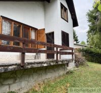 A cottage in Košická Belá with wooden shutters and a stone base.