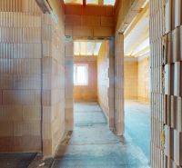 Construction of a family house with brick walls and a concrete floor.