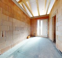 A building in a family house with a view of bricks and raw concrete.