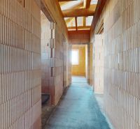 A brick interior hallway under construction, without plaster, Family house.