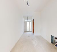 A hallway in a family house with white walls and doors.