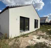A family house in Senec on Karasova Street with an unfinished plot and a simple white facade.