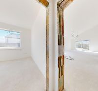 Interior of a family house with large windows and light-colored walls. Construction to be completed.