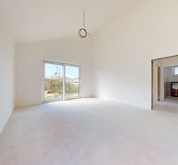A spacious room in a family house with large windows and a view of the garden.