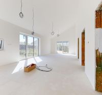 A bright room in a family house with large windows and preparation for the interior.
