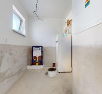 Technical room in a family house with the installation of a toilet and a boiler.