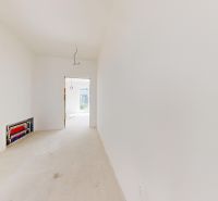 Empty room in a family house with white walls and a concrete floor.