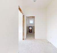 The interior of a family house with an unfinished bathroom, white walls, light floor.
