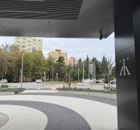 The view from Karpatská Street in Poprad features colorful apartment buildings and greenery.