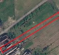 Aerial photograph of the land in Mikušovce, next to the main road and buildings.